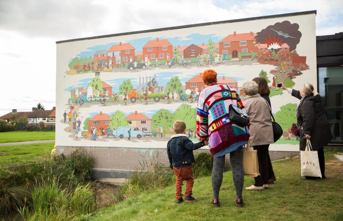 Visitors enoying the Becontree mural This Used to be Fields, a Creative Barking and Dagenham landmark commission with Create and Chad McCail. Photo Emil Charlaff