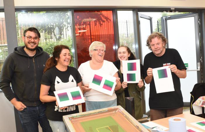 Participants in a screen printing workshop